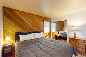 a bedroom with a bed with a wooden wall at Snowcreek 27 in Mammoth Lakes +87 photos