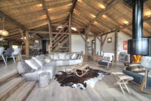 a living room with a couch and a fireplace at Chalet Norel in Les Houches