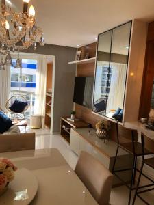 a large living room with a chandelier and a living room at Vista mar sol&mar in Vila Velha