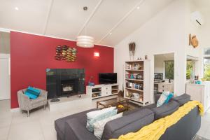 a living room with a couch and a fireplace at Valhalla North & Northern Lodge - waterfront, rural, semi-isolated in Kerikeri