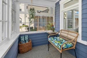 a porch with a chair and a window at Timeless Charm by the Coast, Vintage Beach Bungalow in Long Beach