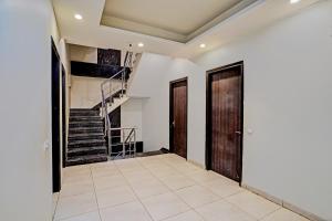 a hallway with two doors and a staircase at Townhouse Akshay Hotel in Gurgaon
