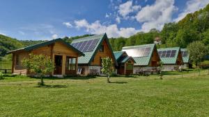 a group of houses with solar panels on their roofs at Princess Jana Apartments in Selišta