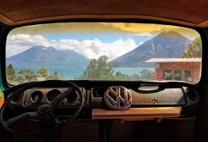 a view from the inside of a car with a steering wheel at El Destino - Rooftop Converted Chicken Bus in San Marcos La Laguna