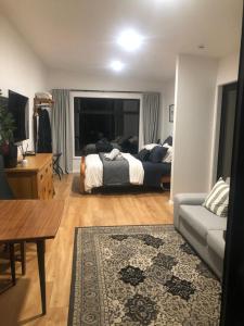 a living room with a bed and a couch at Hamurana Roost in Rotorua