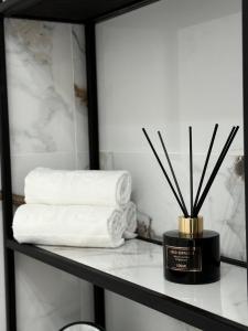 a shelf with a pile of towels and a container of sticks at Sisters residence in Kotor +48 photos