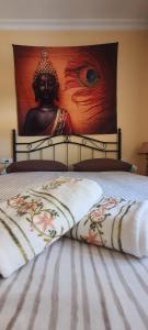 a bed with a head board with a large painting at Rooms Tourist Apartment in Huelva