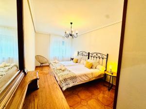 a bedroom with a bed and a chandelier at La Teyera de Pili in Allende
