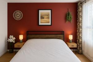 a bedroom with a bed and two tables with lamps at Cozy Family in Angers