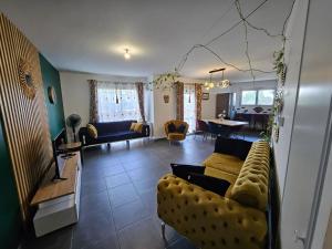 a living room with a couch and a table at Cozy Family in Angers