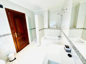 a bathroom with a sink and a tub and a shower at La Teyera de Pili in Allende +32 photos