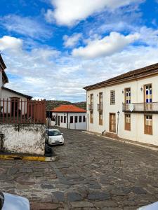 a car parked in a parking lot next to buildings at Casa Rústica da Rua do Carmo - Diamantina - MG in Diamantina