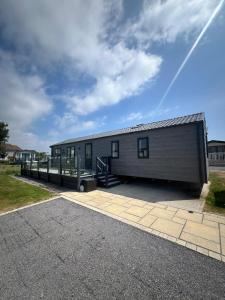 a large gray building with a ramp next to it at The Westwood in Selsey