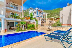 a villa with a swimming pool and a house at Stunning Modern Duplex Apartment in Central Kalkan in Kas