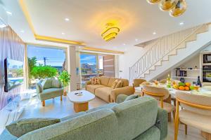 a living room with a couch and a table at Stunning Modern Duplex Apartment in Central Kalkan in Kas