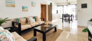 a living room with a couch and a coffee table at AMAR'E beach front apartment overlooking pool in Las Terrenas