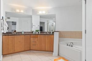 a large bathroom with a tub and a sink at King and Queen 2-Story Loft with 2 Ensuite Baths and Private Balcony at Atlantic Station in Atlanta