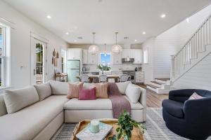 Una sala de estar con un sofá y una cocina. en Barefoot Bungalow 220 ESC-A, en Mustang Beach