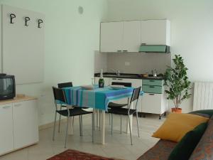 a kitchen with a blue table and chairs in a room at Residence Tre Ponti in Verbania