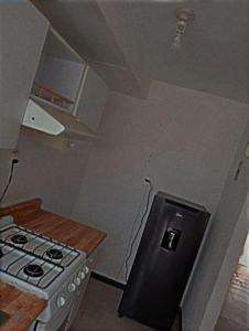 a small kitchen with a stove and a counter at Cómo en Casa in San Juan Xilotzingo
