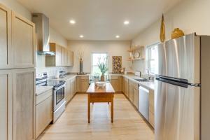 a kitchen with white appliances and a wooden table at Home 21 Mi to Glacier Natl Park Boat, Fish, Hike in Columbia Falls