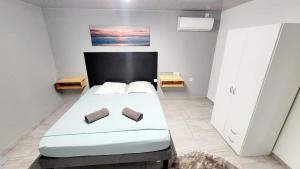 a bedroom with a large white bed with two pillows at Nice Appartement T2 in Saint-Laurent du Maroni
