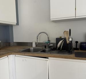 a kitchen with a sink and a counter top at Welcome To Your Home in London