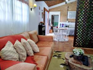 a living room with a couch and a table at Chalé Elohim Campos do Jordão in Campos do Jordão