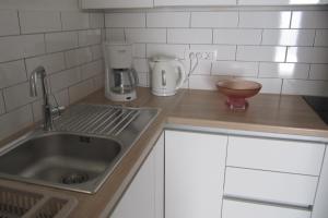 a kitchen counter with a sink and a mixer at Apartments and rooms with a swimming pool Brist, Makarska - 15620 in Brist +33 photos