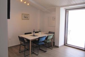 a dining room with a table and chairs at Apartments and rooms with a swimming pool Brist, Makarska - 15620 in Brist