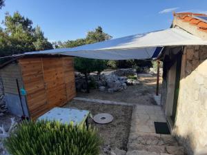 a building with a white umbrella on top of it at Secluded holiday house Pasman - 15649 in Pašman