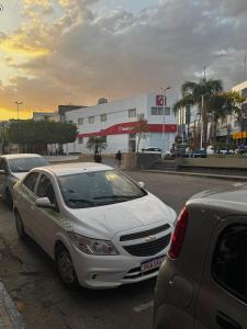 a white car parked on the side of a street at Apartamento mobiliado no centro de Arcoverde in Arcoverde
