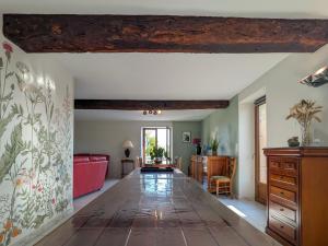a living room with a table and a couch at Gîte à la ferme avec jardin privé, clim et visite de l'exploitation près d'Argenton-sur-Creuse - FR-1-591-321 in Cluis