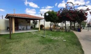a house with a table and chairs in a yard at Condomínio São Francisco in Petrolina