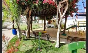 a park with benches and trees and a playground at Condomínio São Francisco in Petrolina
