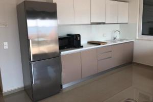 a kitchen with a stainless steel refrigerator and a microwave at Family-friendly apartments with swimming pool Mandre, Pag - 24196 in Kolan