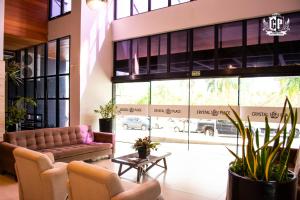 a lobby with a couch in front of a building at Edificio Crystal Place Ap1405 in Goiânia