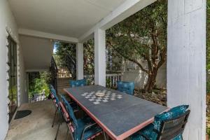 a table and chairs on the back porch of a house at Apartments and rooms by the sea Brela, Makarska - 24416 in Brela +29 photos