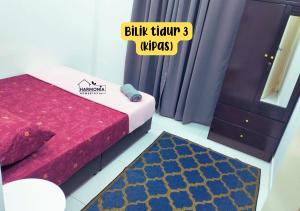 a room with a bed and a mirror and a rug at Harmonia Homestay Terengganu FREE WIFI in Bukit Payong