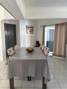 a dining room table with a grey table cloth on it at Aqua Villa in Willemstad