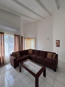 a living room with a couch and a coffee table at Aqua Villa in Willemstad