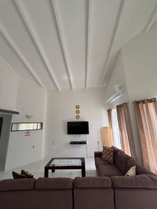 a living room with a couch and a tv at Aqua Villa in Willemstad