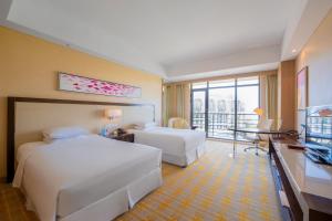 Voodi või voodid majutusasutuse Sheraton Qinhuangdao Beidaihe Hotel toas