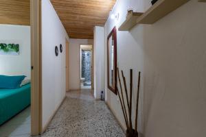 a hallway of a house with a bed and a room with a hallway at apartamento grande, hermoso, acogedor y privado in Medellín