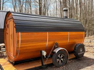 a wooden trailer with a tin roof on a deck at Cover wagon PA Grand Canyon in Gaines