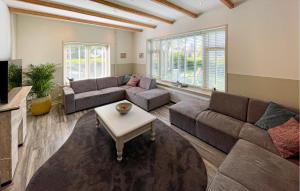 a living room with two couches and a coffee table at Hoeve Aan De Waddenzee in Wierum