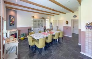 a dining room with a table and chairs and a fireplace at Hoeve Aan De Waddenzee in Wierum