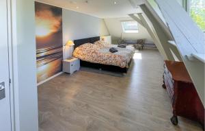 a bedroom with a bed and a staircase at Hoeve Aan De Waddenzee in Wierum
