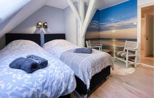a bedroom with two beds and a view of the ocean at Hoeve Aan De Waddenzee in Wierum