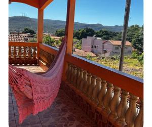 a hammock on a balcony with a view at Residencial Divina in Pirenópolis